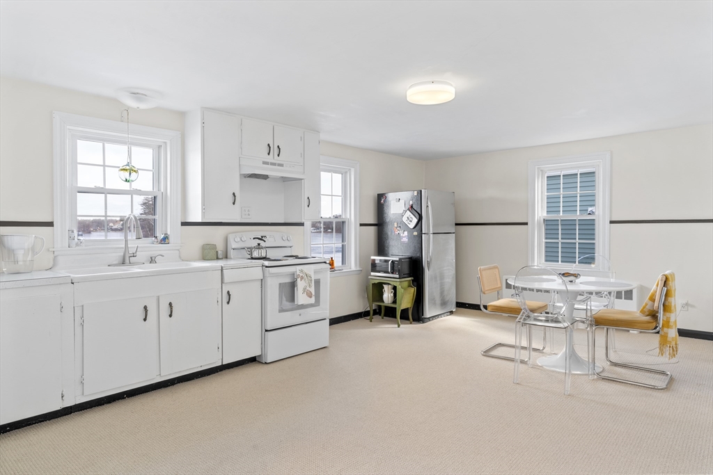 327 Bridle Path Worcester, MA 01604 - Photo 10 of 40 a kitchen with white cabinets and white appliances