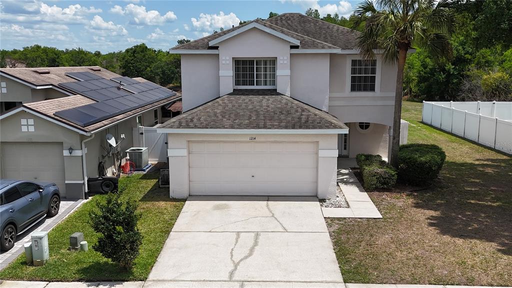 1214 Timberbend Circle Orlando, FL 32824 - Photo 1 of 31 a view of a white house with a small yard and large tree