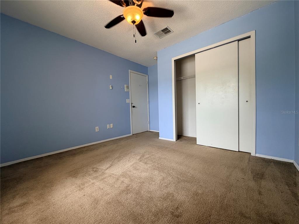 1214 Timberbend Circle Orlando, FL 32824 - Photo 19 of 31 a view of an empty room with a chandelier fan