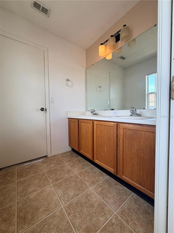 1214 Timberbend Circle Orlando, FL 32824 - Photo 21 of 31 a bathroom with a sink and mirror
