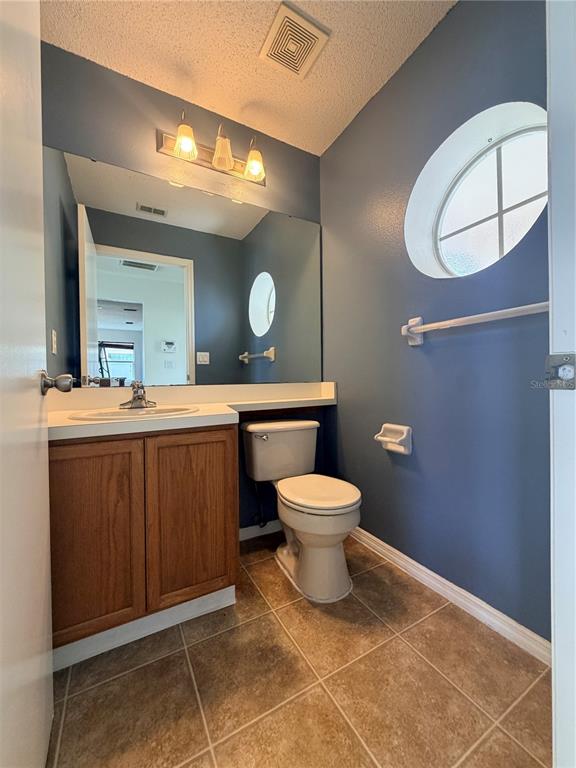 1214 Timberbend Circle Orlando, FL 32824 - Photo 23 of 31 a bathroom with a toilet sink and mirror