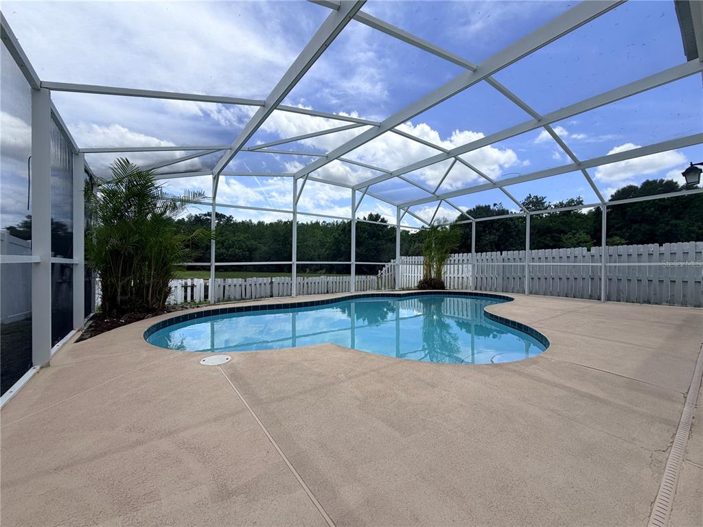 1214 Timberbend Circle Orlando, FL 32824 - Photo 25 of 31 a view of a swimming pool with a patio
