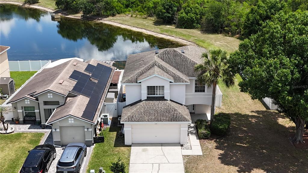 1214 Timberbend Circle Orlando, FL 32824 - Photo 3 of 31 an aerial view of a house with swimming pool and lake view