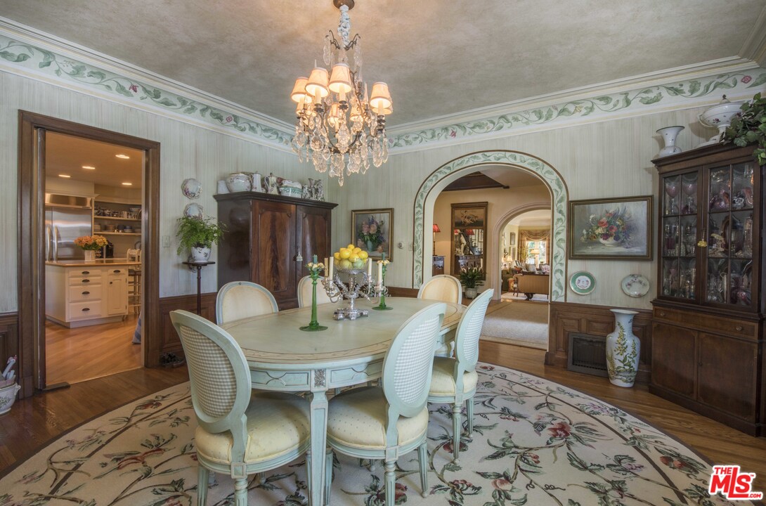 508 South Rimpau Boulevard Los Angeles, CA 90020 - Photo 22 of 48 a view of a dining room with furniture a chandelier and wooden floor