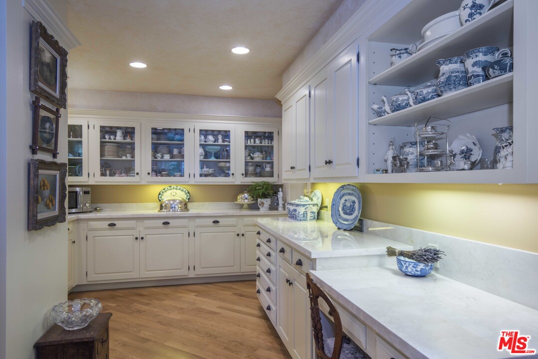 508 South Rimpau Boulevard Los Angeles, CA 90020 - Photo 26 of 48 a kitchen with stainless steel appliances a sink a stove top oven a counter space and cabinets
