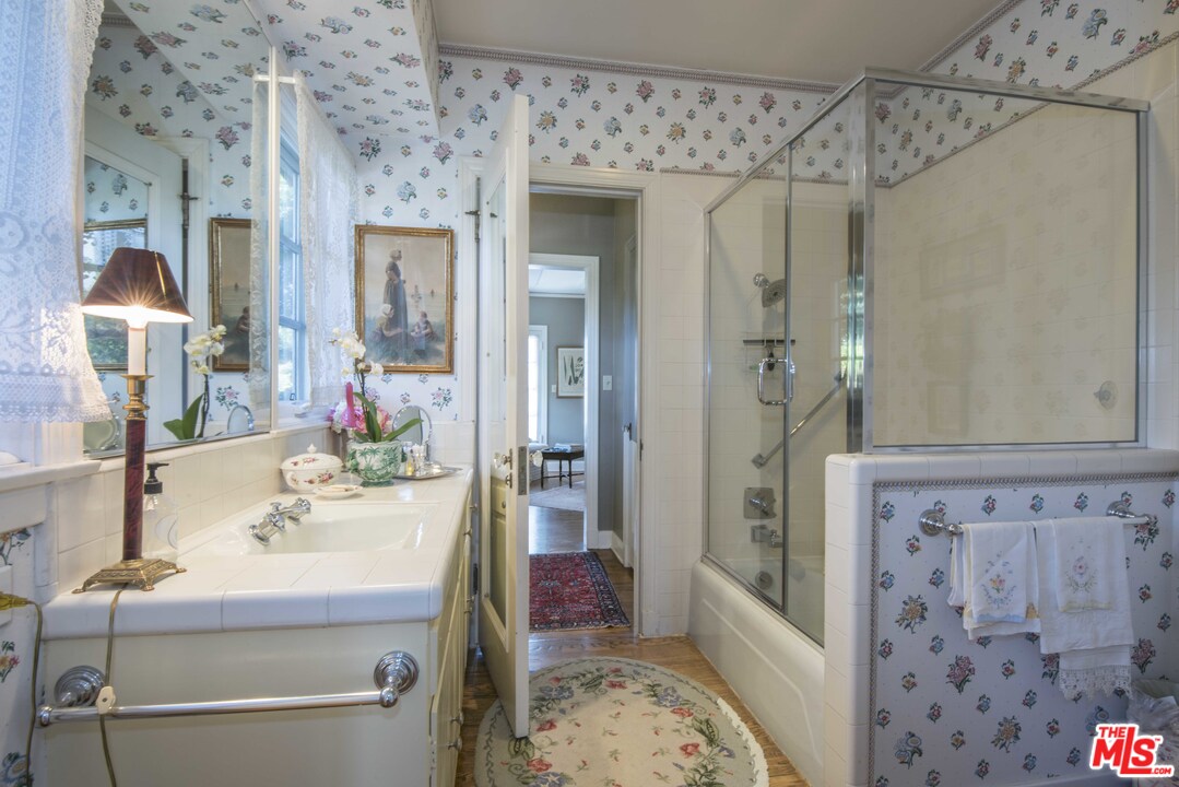 508 South Rimpau Boulevard Los Angeles, CA 90020 - Photo 38 of 48 a bath room with a sink and a mirror