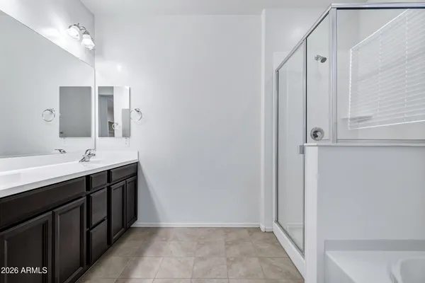 a bathroom with a double vanity sink and mirror