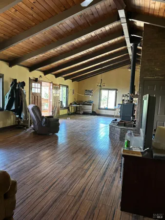a living room with lots of furniture and a wooden floor