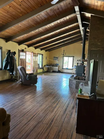 a living room with lots of furniture and a wooden floor