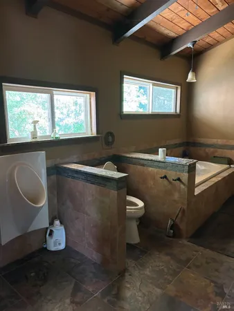 a room with a sink a toilet and a window