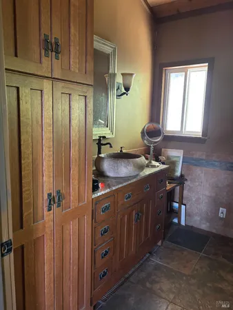 a bathroom with a sink a mirror and a shower