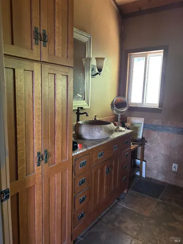 a bathroom with a sink a mirror and a shower