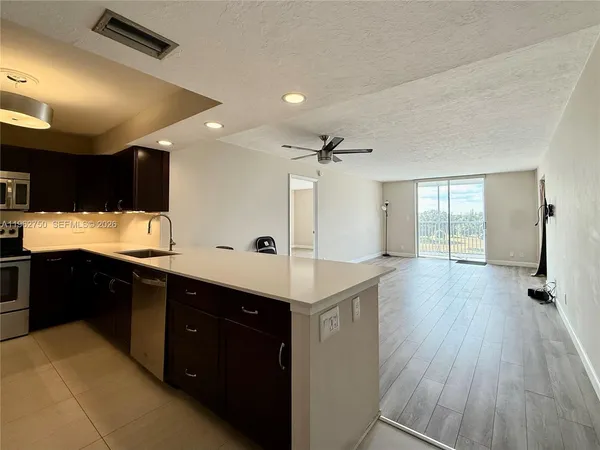 a kitchen with a sink window and cabinets