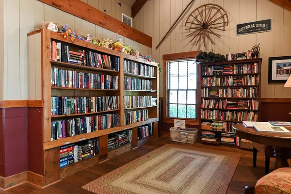 a living room with furniture a fireplace and a large window