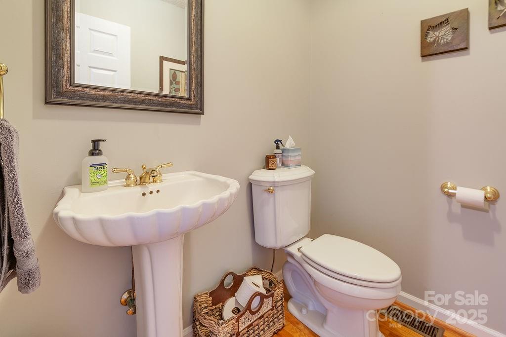 908 Newfound Road Leicester, NC 28748 - Photo 27 of 46 a bathroom with a sink toilet and a mirror