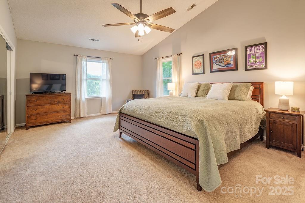 908 Newfound Road Leicester, NC 28748 - Photo 28 of 46 a bedroom with a bed and a chandelier