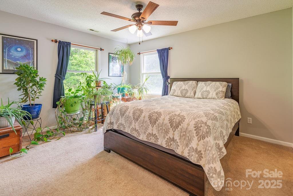 908 Newfound Road Leicester, NC 28748 - Photo 33 of 46 a bed sitting in a bedroom next to a window