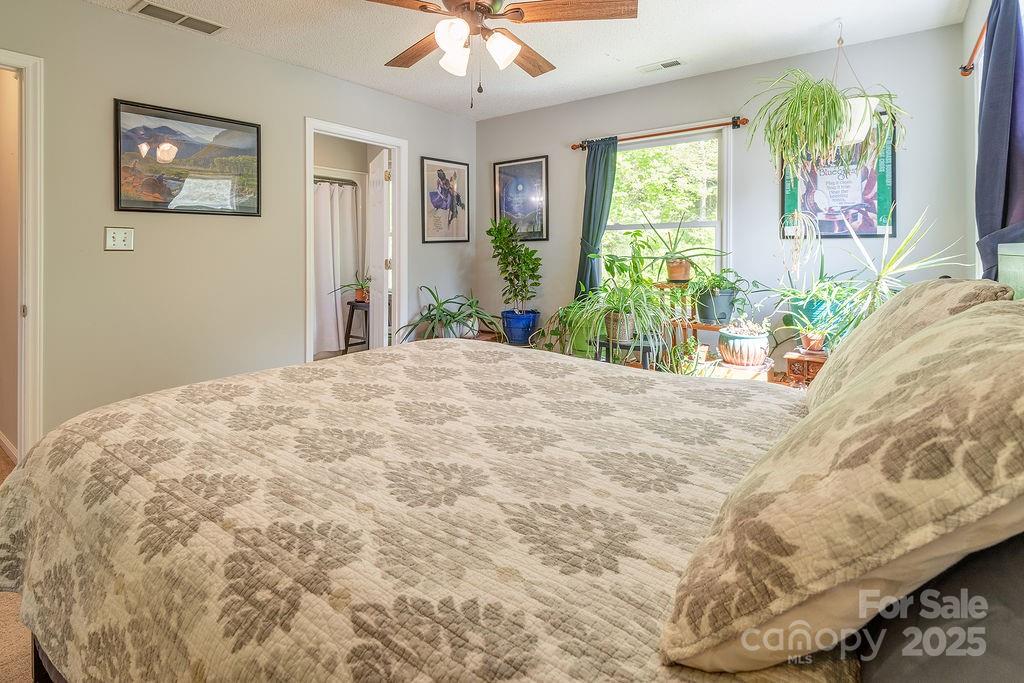 908 Newfound Road Leicester, NC 28748 - Photo 34 of 46 a large bed sitting in a bedroom next to a window