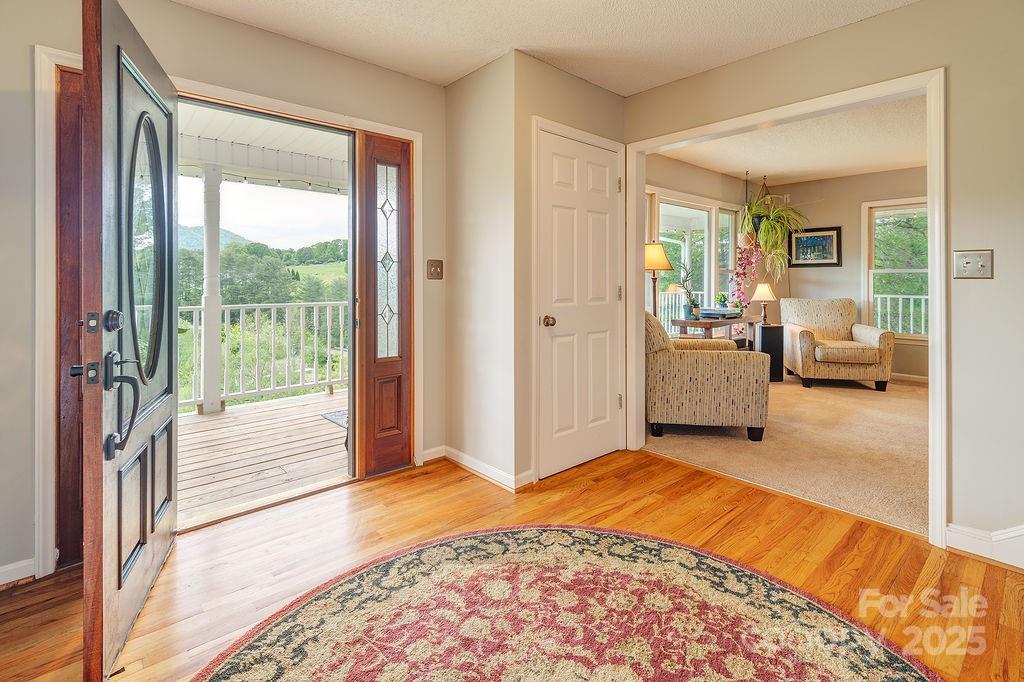 908 Newfound Road Leicester, NC 28748 - Photo 7 of 46 a view of a bedroom with a bed and wooden floor