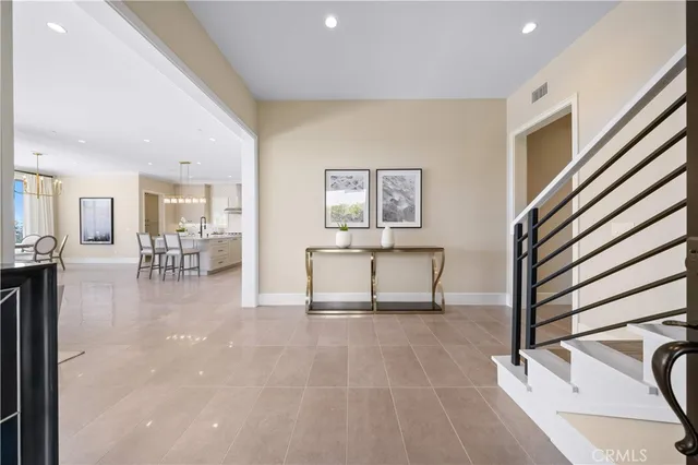 a bed sitting in a spacious bedroom next to a window
