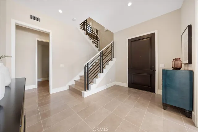 a bedroom with a large bed and a tv