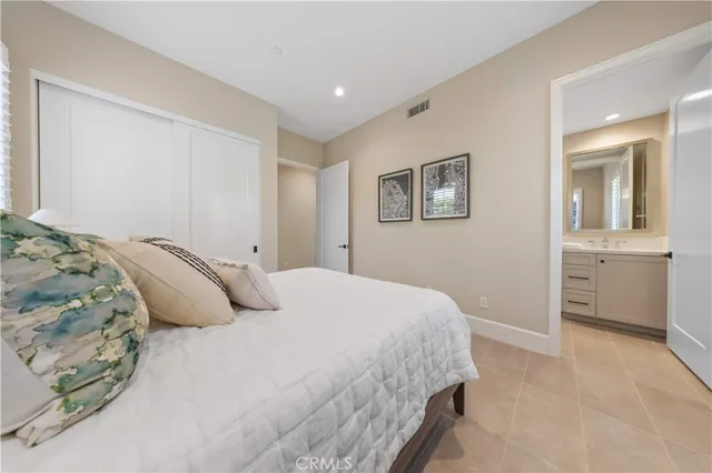 a bathroom with a double vanity sink mirror and toilet
