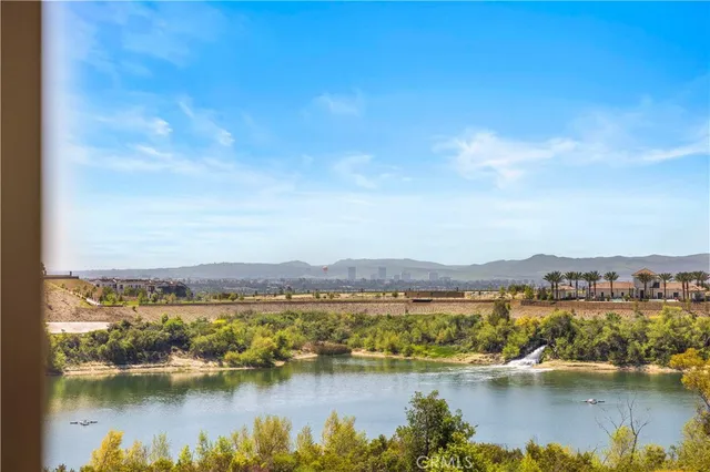 a view of a lake with houses in the back