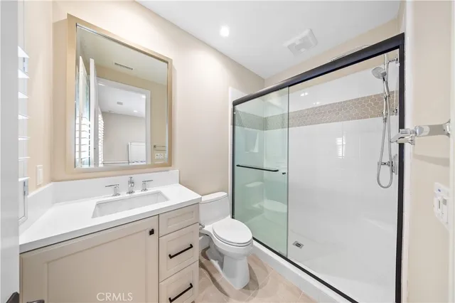 a view of an empty room with closet and a window