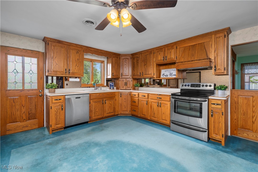 144 Substation Road Brunswick, OH 44212 - Photo 9 of 43 Kitchen featuring appliances with stainless steel finishes, light carpet, and light countertops
