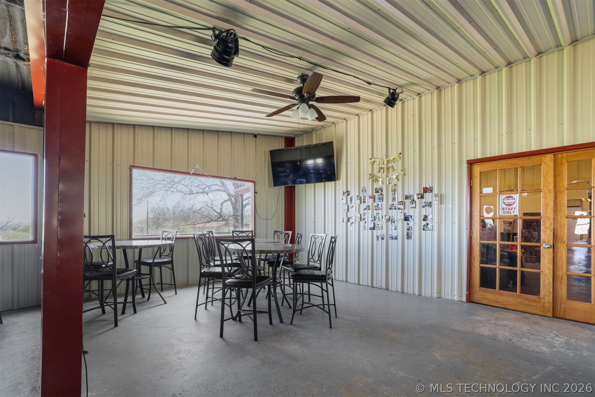 3565 Sawmill Road Caddo, OK 74729 - Photo 13 of 32 Corrugated metal walls and ceiling, concrete flooring, wood frame glass doors, ceiling fan, recessed lighting