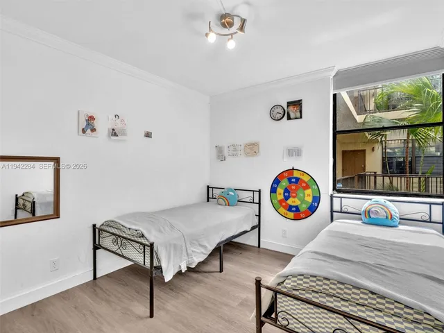 a bedroom with furniture and a window