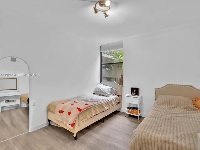 a bedroom with a bed and a night stand