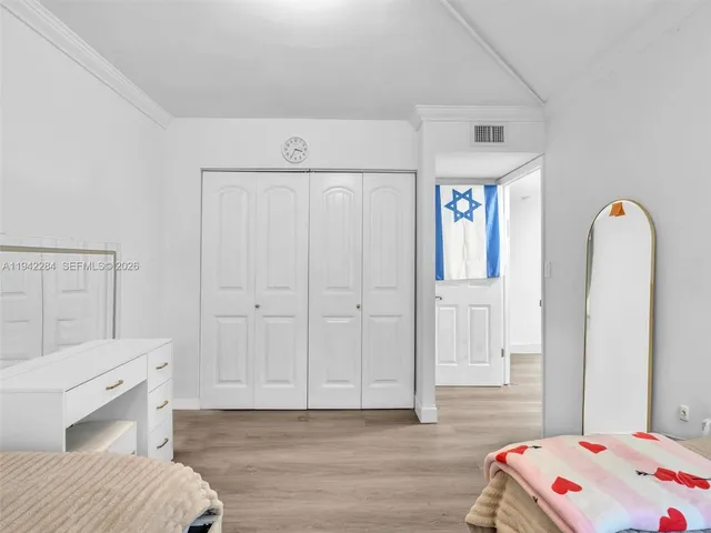 a bedroom with a bed and a dresser