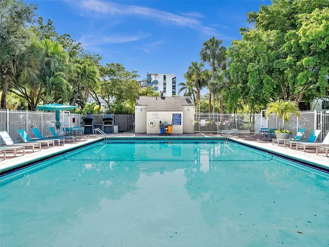 a swimming pool with outdoor seating and yard