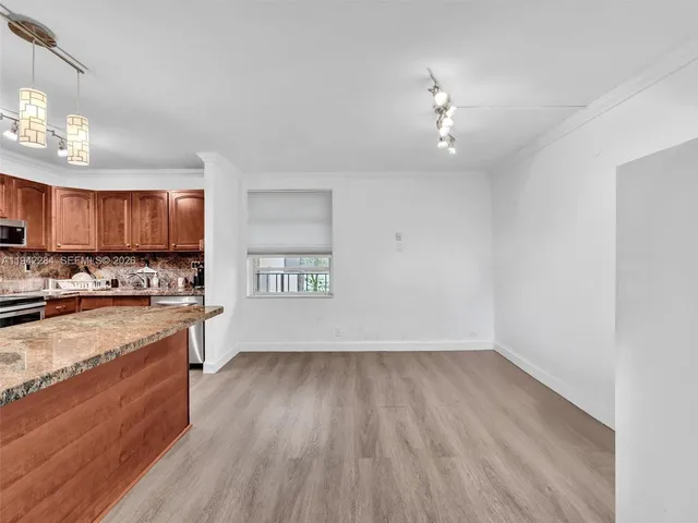 a view of a kitchen with microwave and cabinets