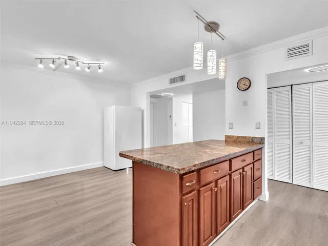 a bathroom with a granite countertop sink a mirror and shower