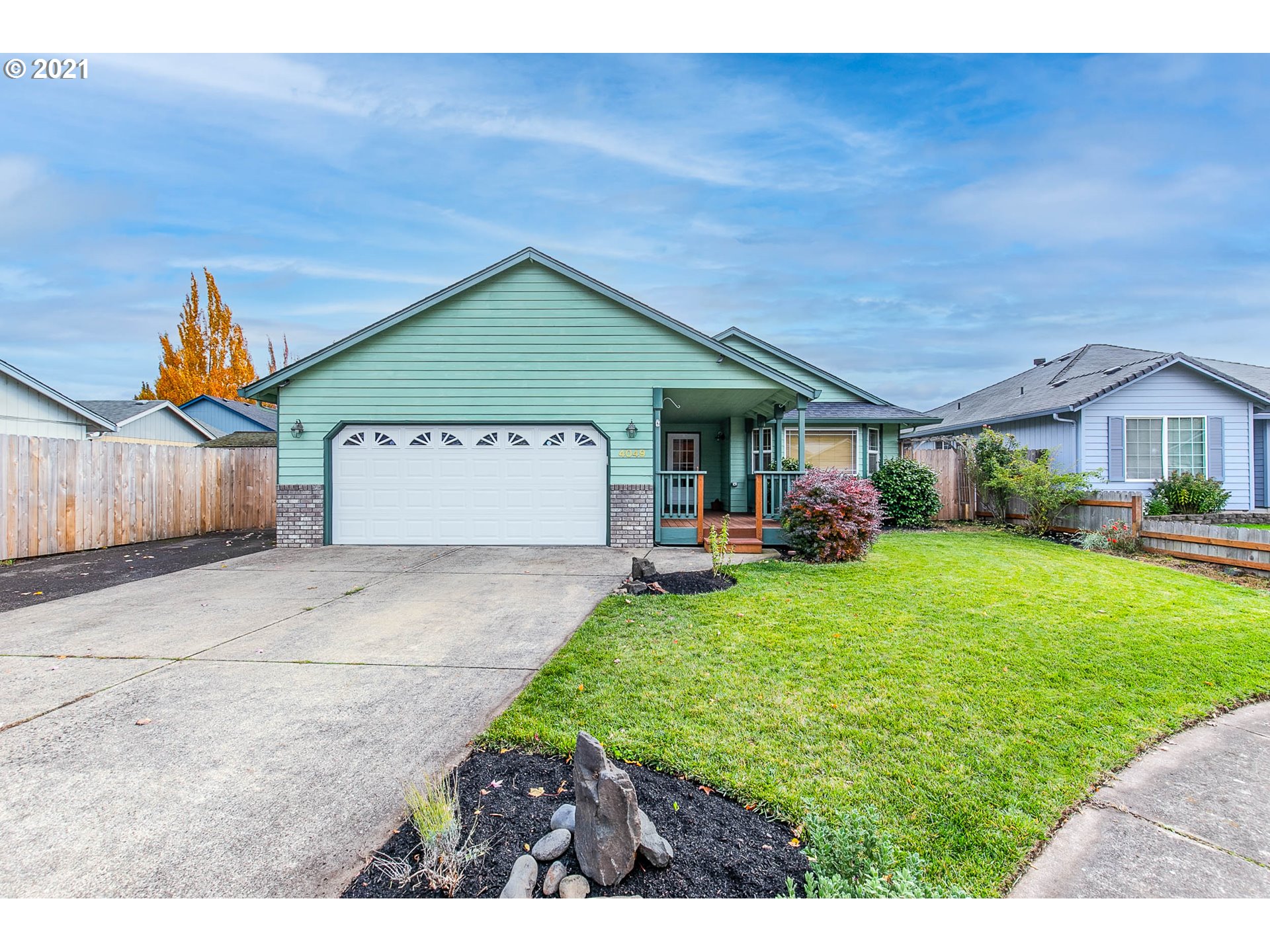 4049 Virginia Avenue Springfield, OR 97478 - Photo 1 of 32 a front view of a house with a yard and garage