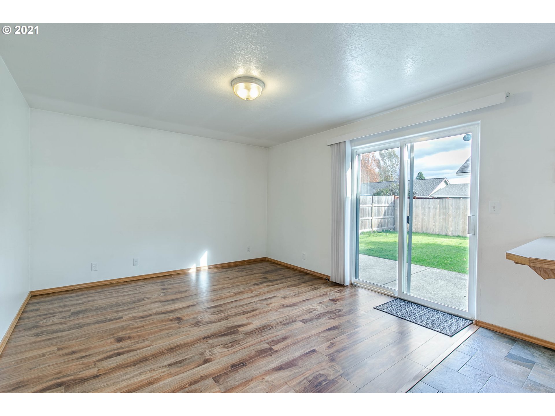 4049 Virginia Avenue Springfield, OR 97478 - Photo 14 of 32 an empty room with wooden floor and windows