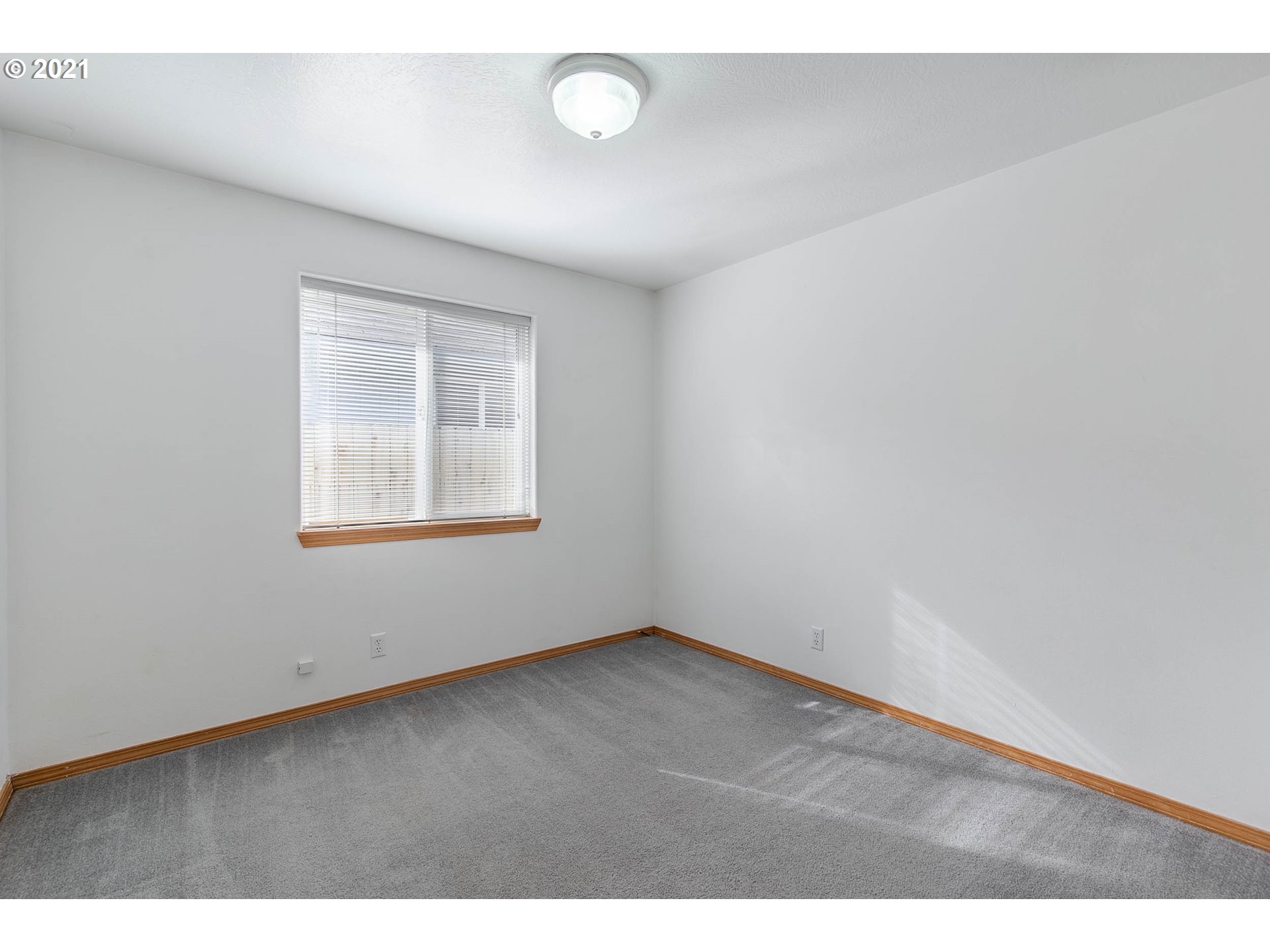 4049 Virginia Avenue Springfield, OR 97478 - Photo 19 of 32 an empty room with wooden floor and windows