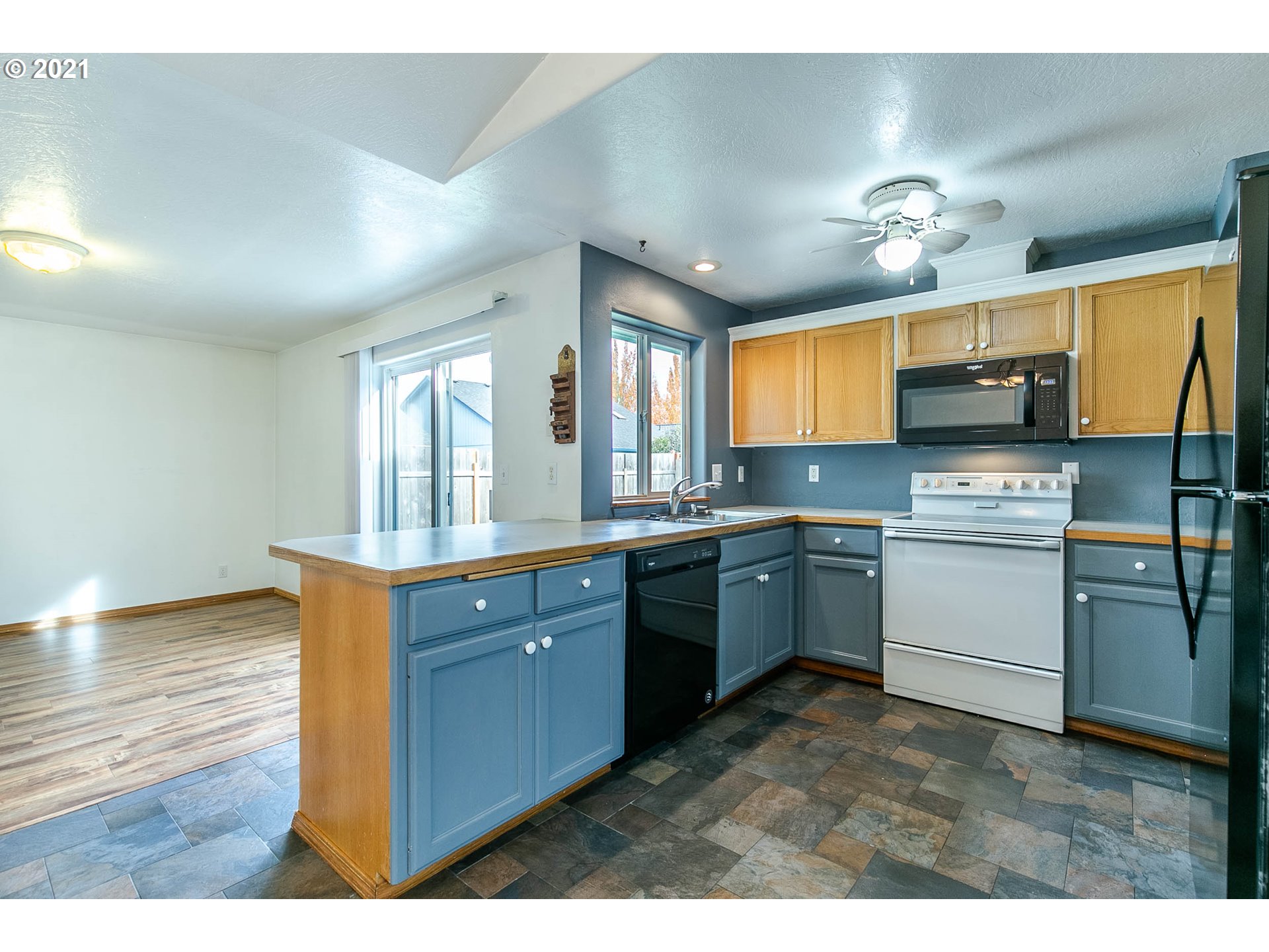 4049 Virginia Avenue Springfield, OR 97478 - Photo 8 of 32 a kitchen with granite countertop a sink cabinets stainless steel appliances and a window
