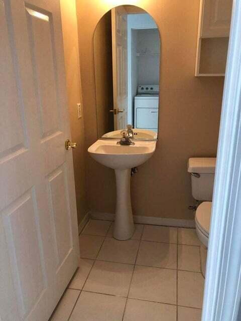 23344 Sunview Way Boca Raton, FL 33428 - Photo 15 of 23 a bathroom with a sink a toilet and mirror