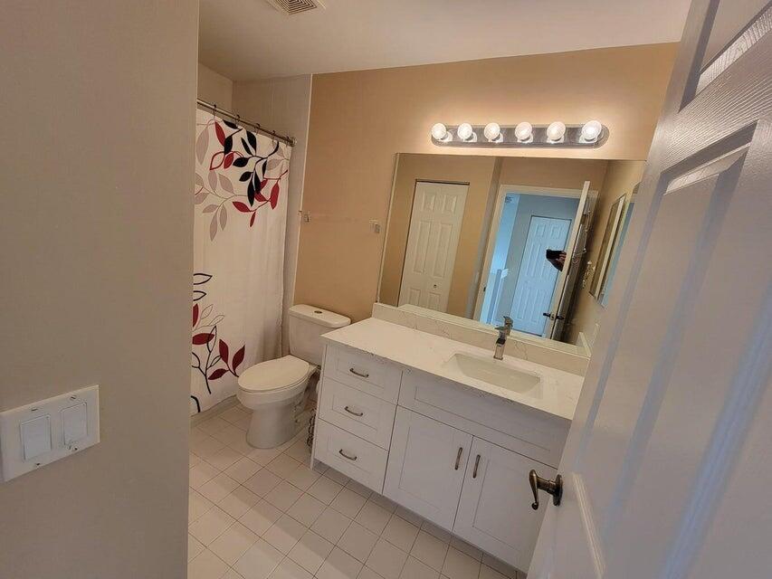 23344 Sunview Way Boca Raton, FL 33428 - Photo 22 of 23 a spacious bathroom with a double vanity sink mirror and toilet