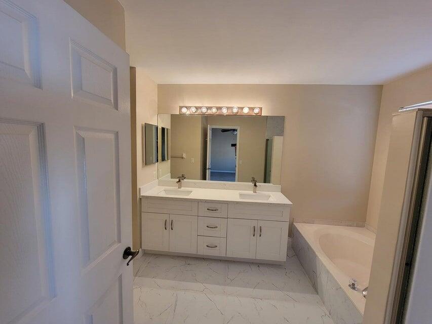 23344 Sunview Way Boca Raton, FL 33428 - Photo 23 of 23 a spacious bathroom with a tub sink and mirror