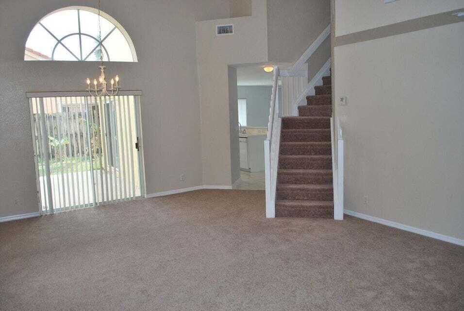 23344 Sunview Way Boca Raton, FL 33428 - Photo 9 of 23 en view of empty room with stairs and wooden floor