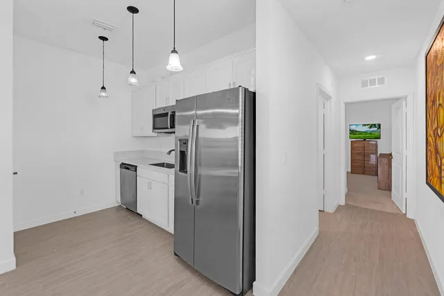 a living room with furniture a flat screen tv and a window