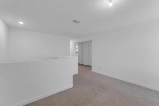 a bedroom with a bed and a ceiling fan