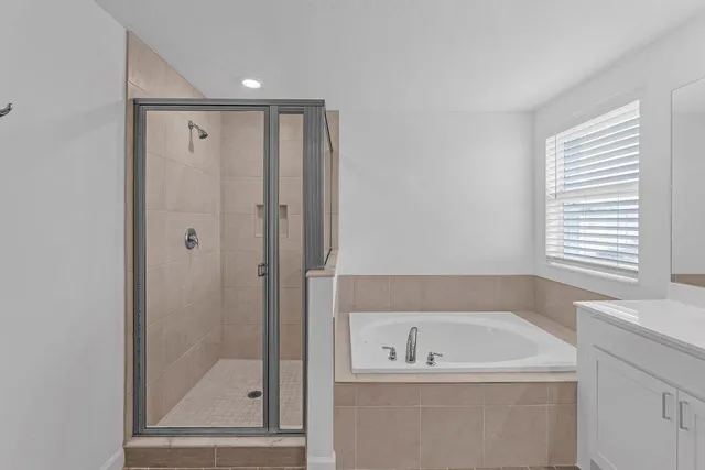 a bathroom with a double vanity sink and mirror with toilet