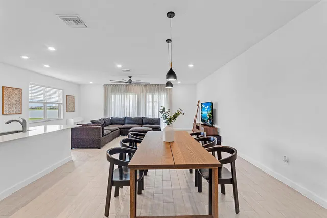 a kitchen with stainless steel appliances a stove a microwave a sink and white cabinets