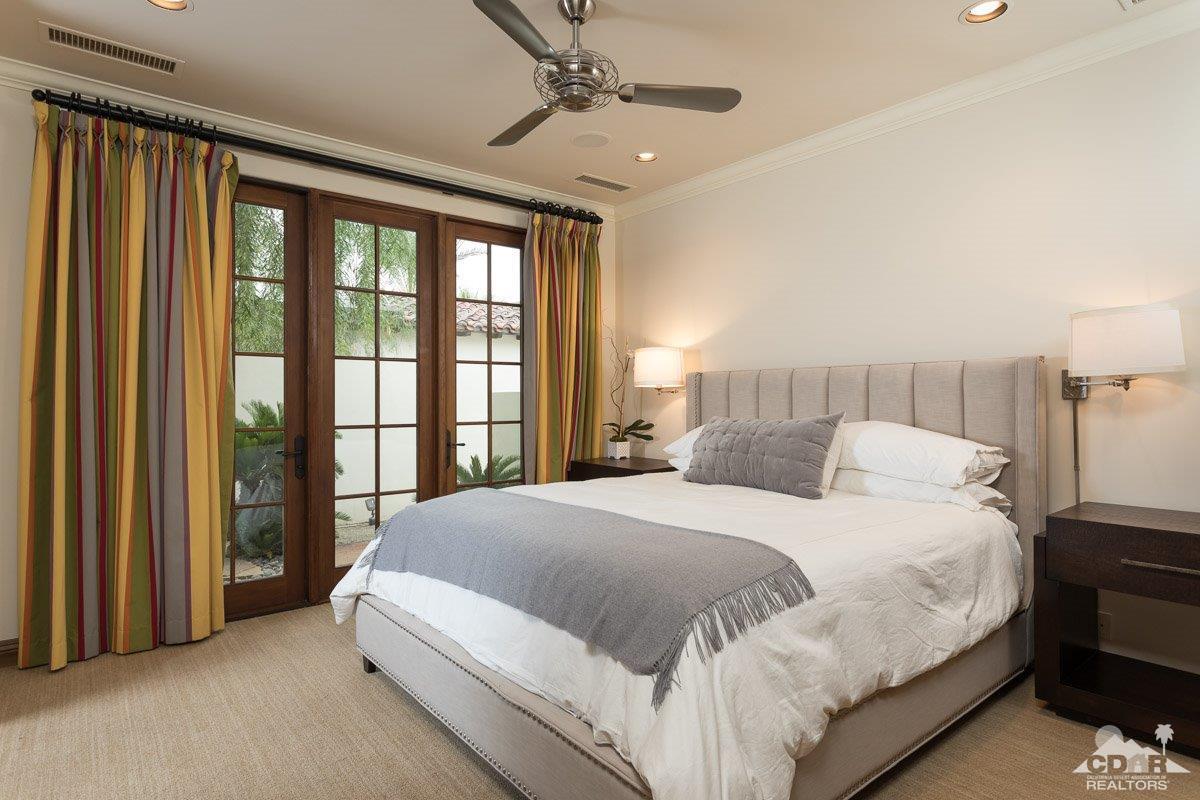 1 Santa Rosa Mountain Lane Rancho Mirage, CA 92270 - Photo 12 of 23 a bedroom with a large bed and a chandelier fan