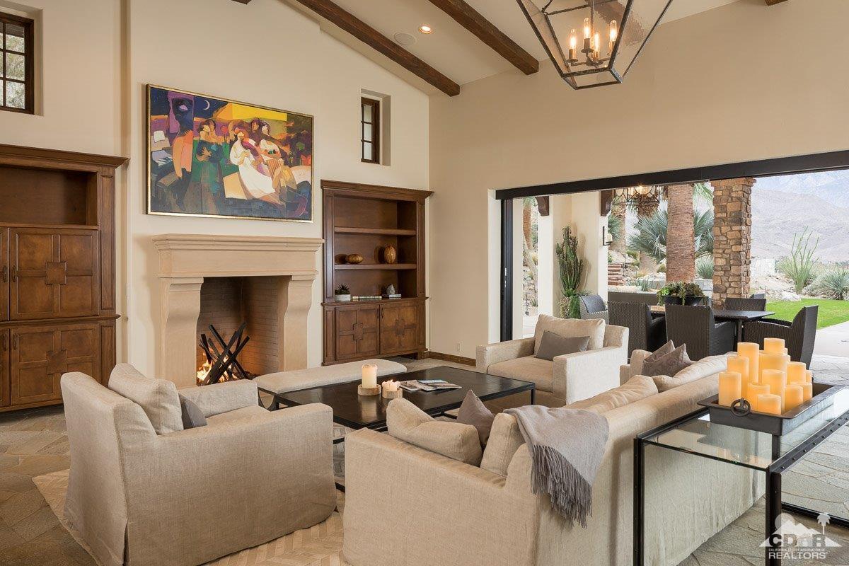 1 Santa Rosa Mountain Lane Rancho Mirage, CA 92270 - Photo 4 of 23 a living room with furniture a large window and a fireplace
